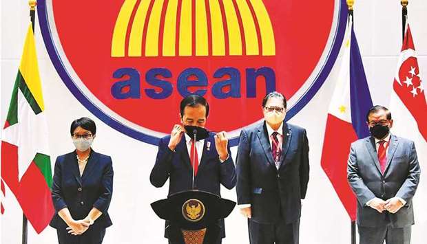 This handout photograph taken yesterday and released by the Indonesian Presidential Palace shows Indonesian President Joko Widodo adjust his facemask while delivering his speech at the Asean Myanmar crisis talks in Jakarta.