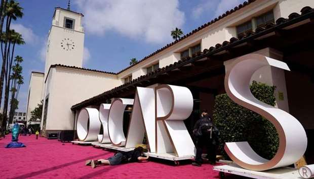 An Academy Awards crew member prepares a backdrop for the red carpet at Union Station, one of the locations for Sunday's 93rd Academy Awards, April 24 in Los Angeles. AFP