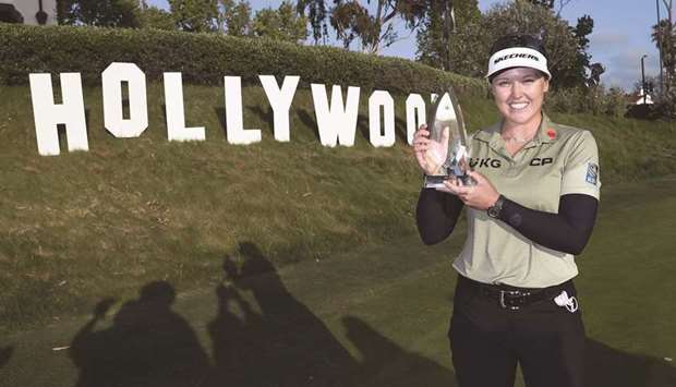 Brooke Henderson of Canada poses with the championship trophy after winning the LA Open at Wilshire Country Club in Los Angeles, California. (Getty Images/AFP)