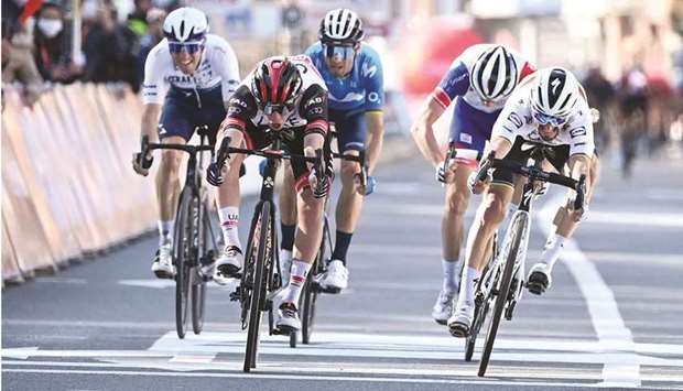 Slovenian Tadej Pogacar (left) of the UAE Team Emirates crosses the finish line and win ahead of French Julian Alaphilippe of team Deceuninck-Quick-Step during the Liege-Bastogne-Liege cycling race in Liege yesterday. (AFP)