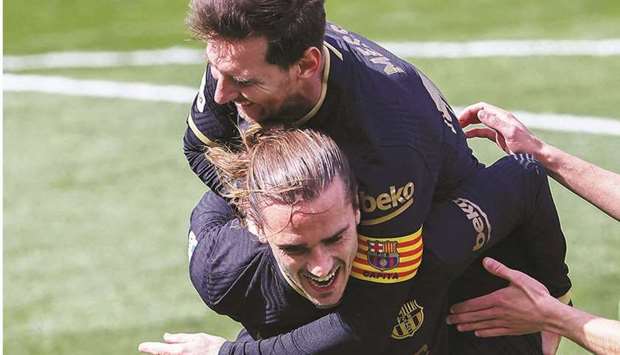 Barcelonau2019s Antoine Griezmann (left) celebrates with captain Lionel Messi after scoring against Villarreal in the La Liga yesterday. (AFP)