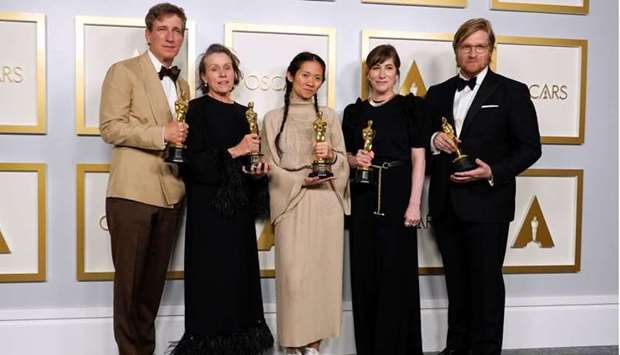 Peter Spears, Frances McDormand, Chloe Zhao, Mollye Asher and Dan Janvey, winners of the award for best picture for ,Nomadland,, pose in the press room at the Oscars, in Los Angeles, California