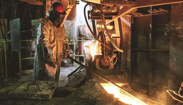 A worker in heat resistant protective clothing on the liquid copper mould  production line at the KGHM Polska Miedz smelting plant in Glogow, Poland. Copper climbed to the highest in almost a decade as the global recovery from the pandemic extended a rally in metals markets.