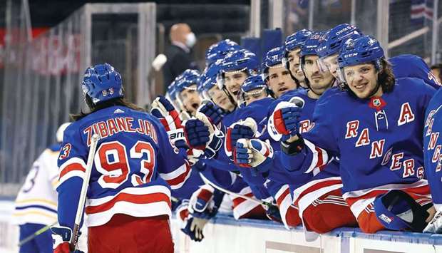 Mika Zibanejad of the New York Rangers is congratulated by teammates after he scored a hat-trick in the second period against the Buffalo Sabres at Madison Square Garden in New York City. (USA TODAY Sports)