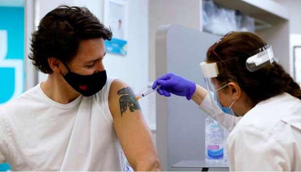 Canada's Prime Minister Justin Trudeau is inoculated with AstraZeneca's vaccine against coronavirus disease (Covid-19) at a pharmacy in Ottawa, Ontario, Canada April 23, 2021.