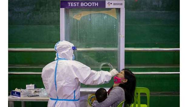 (File photo) A woman gets a free coronavirus disease (COVID-19) swab testing at a gymnasium in Navotas City, Metro Manila, Philippines, recently. (Reuters)