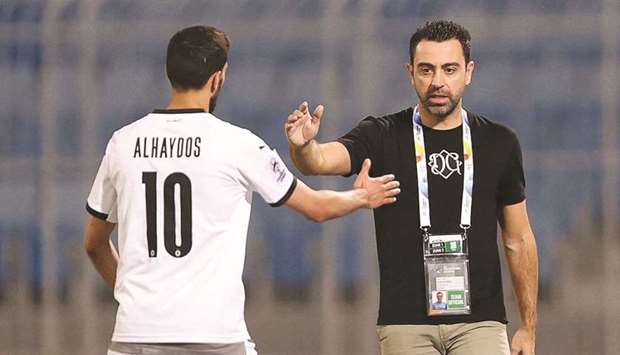 Al Sadd head coach Xavi (right) with captain Hassan al-Haydos after their win over Foolad Khouzestan in the AFC Champions League in Riyadh on Monday.