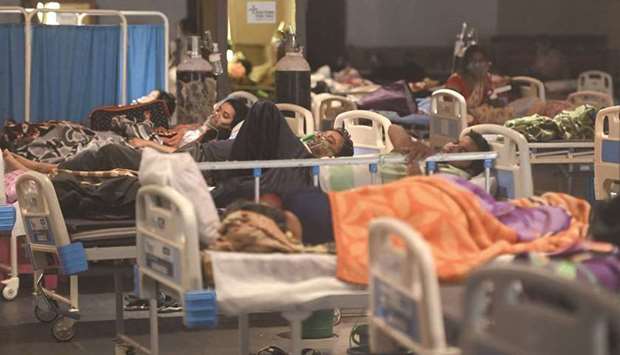 Patients breath with the help of oxygen masks inside a banquet hall temporarily converted into a Covid-19 coronavirus ward in New Delhi yesterday.