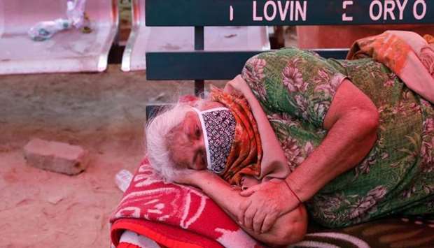 A woman suffering from a breathing difficulty due to the coronavirus disease waits to receive oxygen support for free outside a Gurudwara (Sikh temple) in Ghaziabad, India
