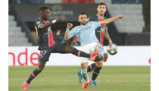 Paris Saint-Germainu2019s Idrissa Gueye (left) and Leandro Paredes (right) vie for the ball with Manchester Cityu2019s Riyad Mahrez during their UEFA Champions League semi-final first leg match at Parc des Princes in Paris, France, yesterday. (Reuters)