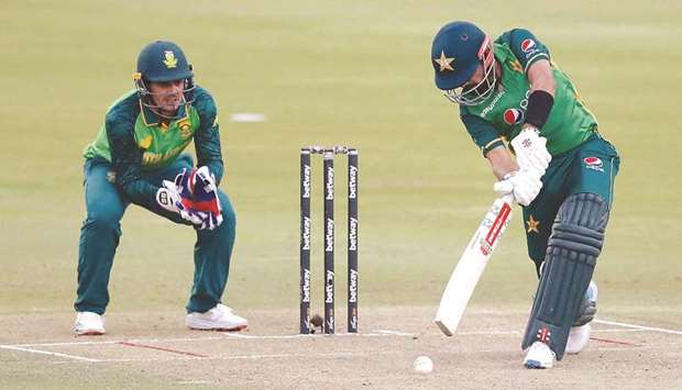 Pakistanu2019s captain Babar Azam (right) plays a shot as South African wicketkeeper Quinton de Kock looks on during the first ODI at SuperSport Park in Centurion, South Africa, yesterday. (AFP)