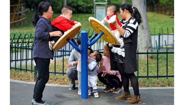 Women play with children at a park in Jinhua, Zhejiang province, China. (Reuters)