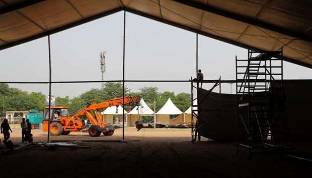 Labourers build a temporary Covid-19 care facility, at Ramlila grounds, amidst the spread of the coronavirus disease in New Delhi, India