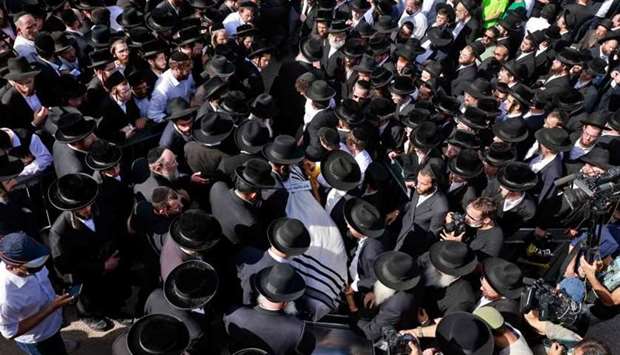 Ultra-Orthodox Jewish men take part in a funeral ceremony in Jerusalem for a victim of an overnight stampede during a religious gathering in northern Israel