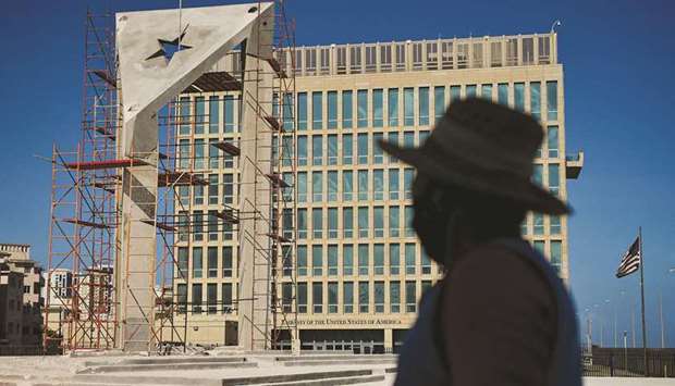 A worker looks at a huge concrete Cuban flag being build in front of the US embassy in Havana.