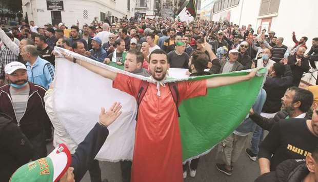 A demonstrator takes part in a protest demanding political change, in Algiers, yesterday.