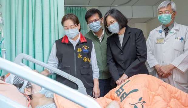 Taiwan President Tsai Ing-wen visits a victim of the deadly train derailment at a hospital in Hualien, Taiwan