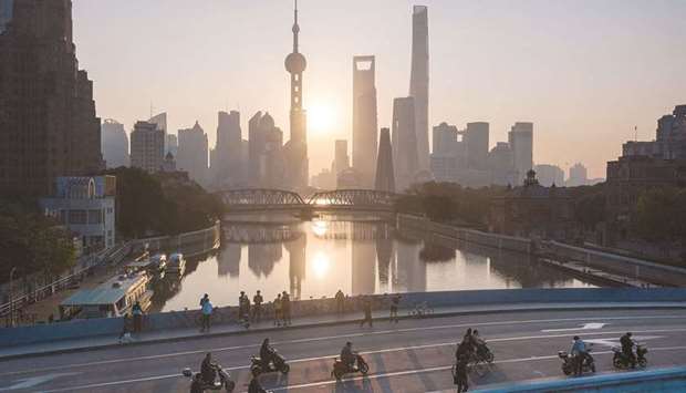 DOMINANCE: Sunrise in Shanghaiu2019s financial district of Pudong. (AFP)