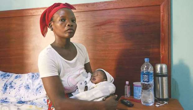 Fato Abdula Ali, who gave birth while fleeing an attack claimed by Islamic State-linked insurgents on the town of Palma, sits with her child at a hotel in Pemba, Mozambique yesterday. (Reuters)