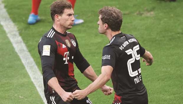 Bayern Munichu2019s Leon Goretzka (L) celebrates with Thomas Muller after scoring against Leipzig yesterday.