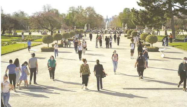 People enjoy warm weather at Les Jardins des Tuileries park in Paris. u201cClosing education establishments and 150,000 stores is essential to slow the spread of the virus, but these measures will have an impact on the French economy,u201d Le Maire told Le Journal du Dimanche newspaper in an interview published yesterday.