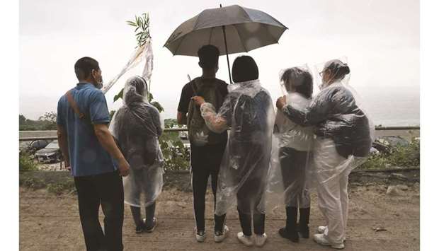Relatives of the victims mourn near the site a day after the deadly train derailment at a tunnel in Hualien.