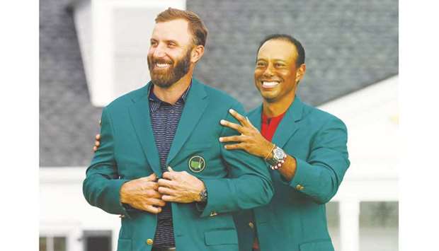 In this November 15, 2020, picture, Dustin Johnson of the US is presented with the green jacket by compatriot Tiger Woods after winning The Masters in Augusta, Georgia, United States. (Reuters)