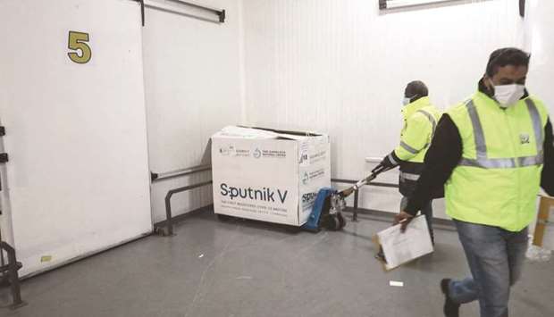 Workers handle boxes of the newly-received first batch of the Russian Sputnik V vaccine against the coronavirus, before stockpiling them in refrigerated units inside the storage facilities of the Libyan health ministry, in the capital Tripoli, yesterday.