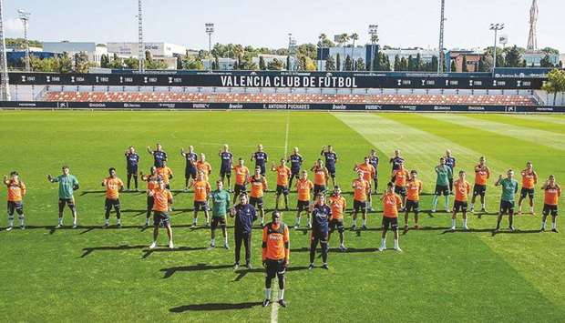 Valencia players and staff show their support to their French defender Mouctar Diakhaby (centre) as they protest against racism during a training session in Valencia, Spain, yesterday. (AFP)