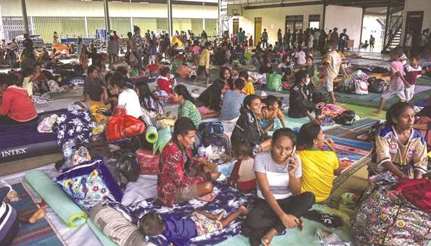 Residents take refuge at an evacuation centre after fleeing their damaged homes in Dili, East Timor yesterday, after torrential rains triggered floods and landslides.