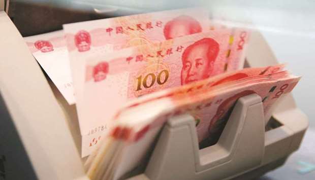 Chinese 100 yuan banknotes are seen in a counting machine at a branch of a commercial bank in Beijing (file).