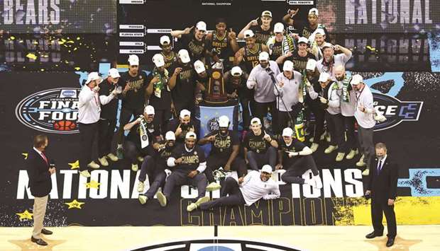The Baylor Bears pose with the National Championship trophy after winning the National Championship game of the 2021 NCAA Menu2019s Basketball Tournament against the Gonzaga Bulldogs at Lucas Oil Stadium in Indianapolis, Indiana. The Baylor Bears defeated the Gonzaga Bulldogs 86-70. (Getty Images/AFP)