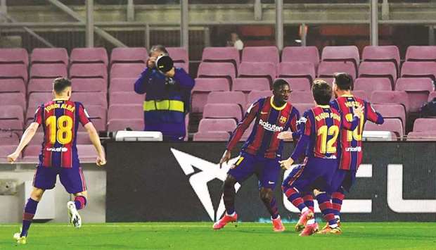 Barcelonau2019s Ousmane Dembele (centre) celebrates with teammates after scoring against Real Valladolid in the La Liga at the Camp Nou stadium in Barcelona. (AFP)
