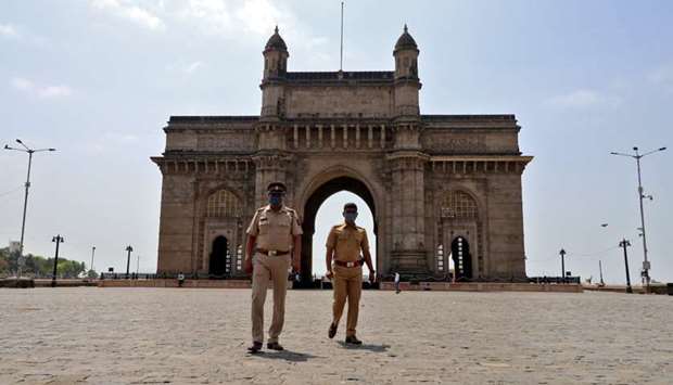 Police officers patrol at the empty Gateway of India monument, amidst the spreading of coronavirus d