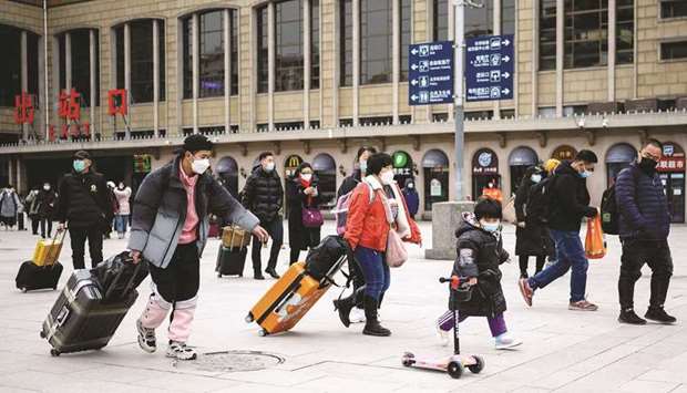 People arrive at the Beijing railway station (file).