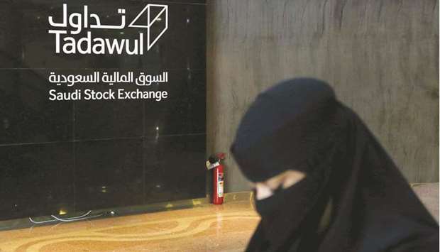 A Saudi woman walks at the Saudi stock market (Tadawul), in Riyadh (file). Saudi Arabia has been a hot market for IPOs in the Middle East over the past two years, with new offerings oversubscribed, mostly by local retail and institutional investors.