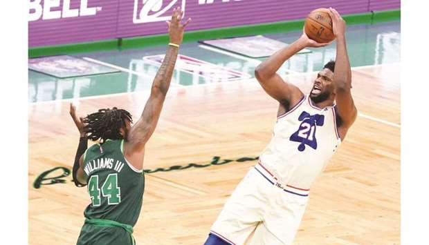 Philadelphia 76ers center Joel Embiid (right) shoots for three points against Boston Celtics center Robert Williams III in the third quarter at TD Garden in Boston. (USA TODAY Sports)