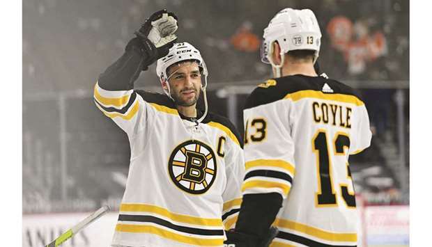 Boston Bruins center Patrice Bergeron (left) and center Charlie Coyle (13) celebrate their win against the Philadelphia Flyers at Wells Fargo Center in Philadelphia. (USA TODAY Sports)