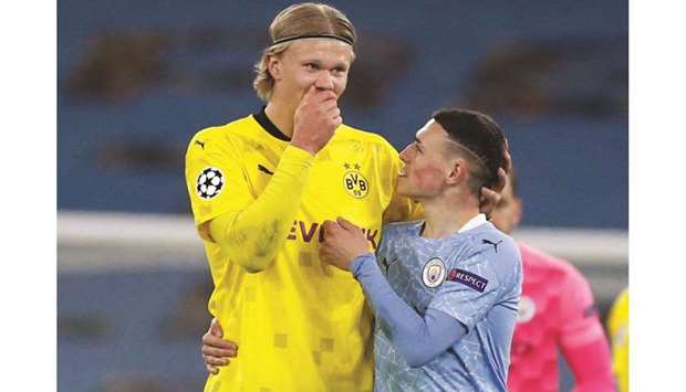 Borussia Dortmundu2019s Erling Braut Haaland (left) talks to Manchester Cityu2019s Phil Foden after the Champions League quarter-final in Manchester on Tuesday. (Reuters)
