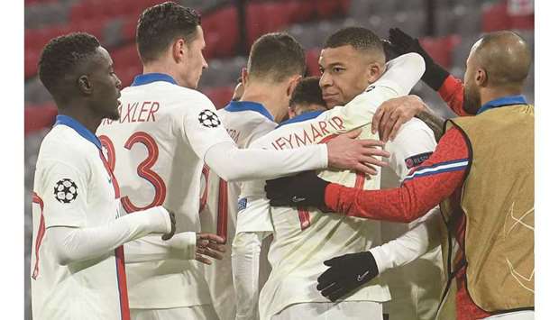 Paris Saint-Germainu2019s Kylian Mbappe (second from right) celebrates with his teammates after scoring a goal against Bayern Munich during their UEFA Champions League quarter-final first leg match in Munich, Germany, yesterday. (AFP)