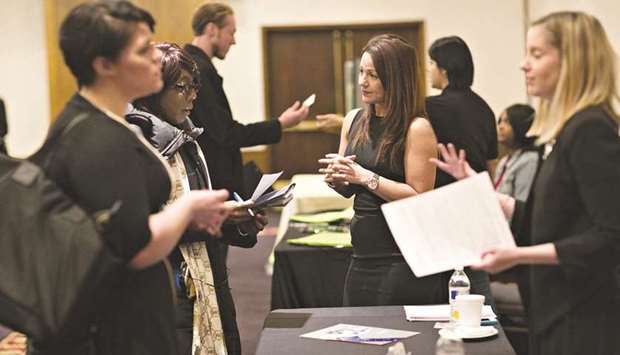Company representatives talk with job seekers during a National Career Fairs job fair in Chicago (file). New filings for US unemployment benefits increased for the second week in a row, according to government data released yesterday, defying analystsu2019 expectations of a drop as the economy reopens.