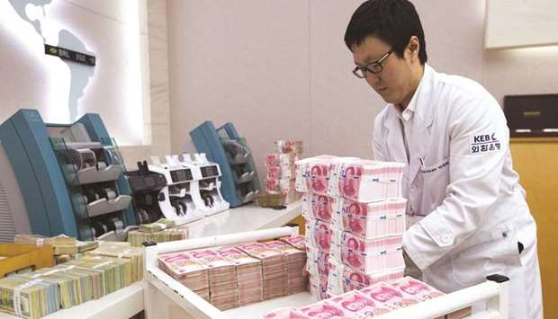 An employee arranges yuan banknotes at the Korea Exchange Bank headquarters in Seoul.
