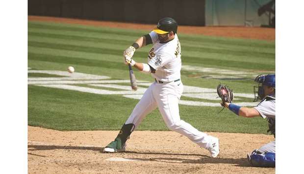 Oakland Athletics first baseman Mitch Moreland hits an RBI single for a walk-off win against the Los Angeles Dodgers during the tenth inning in Oakland, California. (USA TODAY Sports)