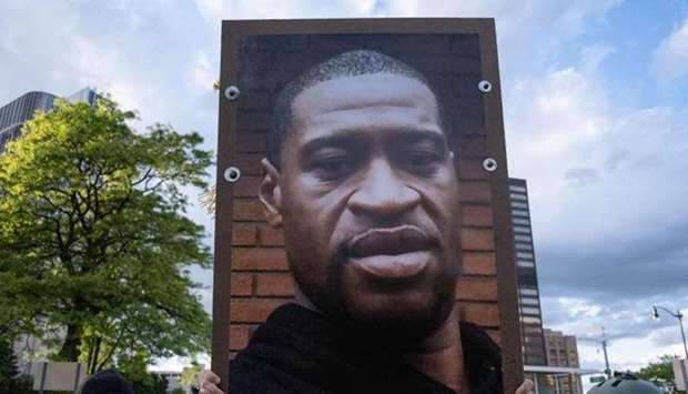 (File photo) Protestor hold a picture of George Floyd at a protest in Detroit, Michigan. (AFP)