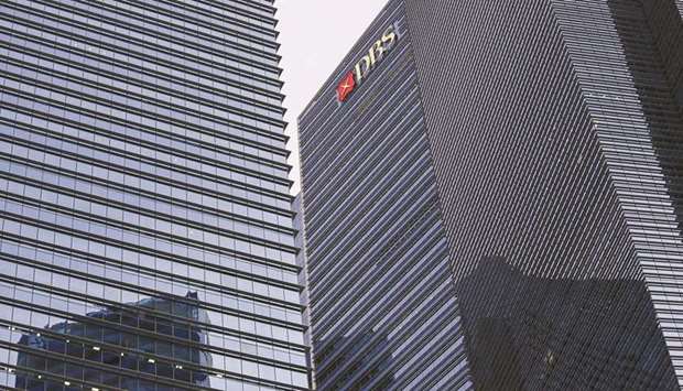 The DBS Group Holdings logo is displayed atop Tower 3 of the Marina Bay Financial Centre in Singapore. DBS Group is poised to trim office space in Singapore, the latest bank to pare its footprint in the city-state during the coronavirus pandemic.a