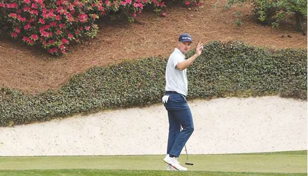 Englandu2019s Justin Rose reacts after holing his birdie putt during the second round of the Masters yesterday.