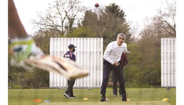 London Mayor Sadiq Khan plays cricket during a London mayoral election campaign visit to Kingstonian Cricket Club in southwest London yesterday. (AFP)