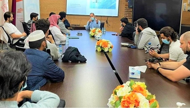 Qatar University students and Boeing official during a meeting.