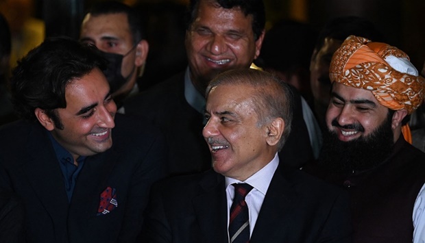 Pakistan's opposition leader Shahbaz Sharif (C) and Bilawal Bhutto Zardari (R) smile during a press conference with other parties leaders in Islamabad on April 7, 2022 after a Supreme Court verdict. 