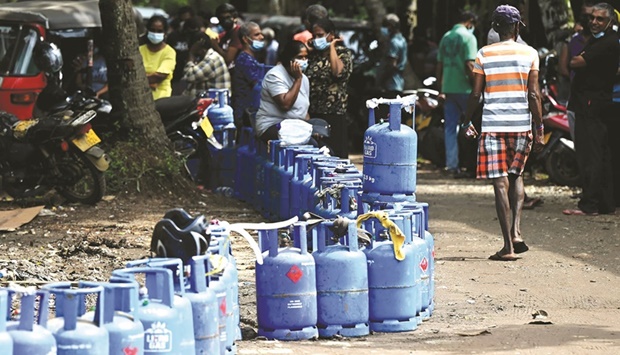 People queue to buy liquefied petroleum gas (LPG) cylinders in Colombo yesterday.